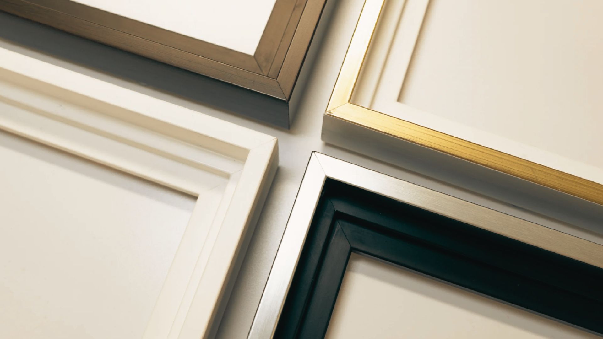 A collection of elegant picture frames with gold trim, arranged artistically on a display surface.