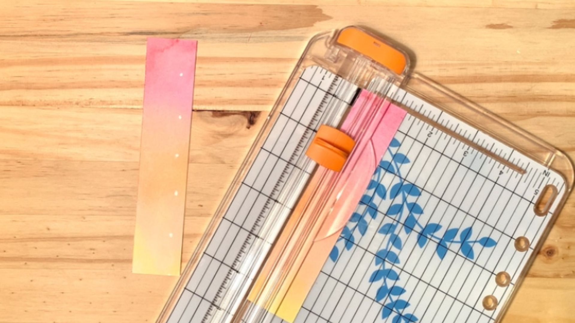 A piece of paper with a ruler and scissors placed on top, suggesting a crafting or measurement activity.