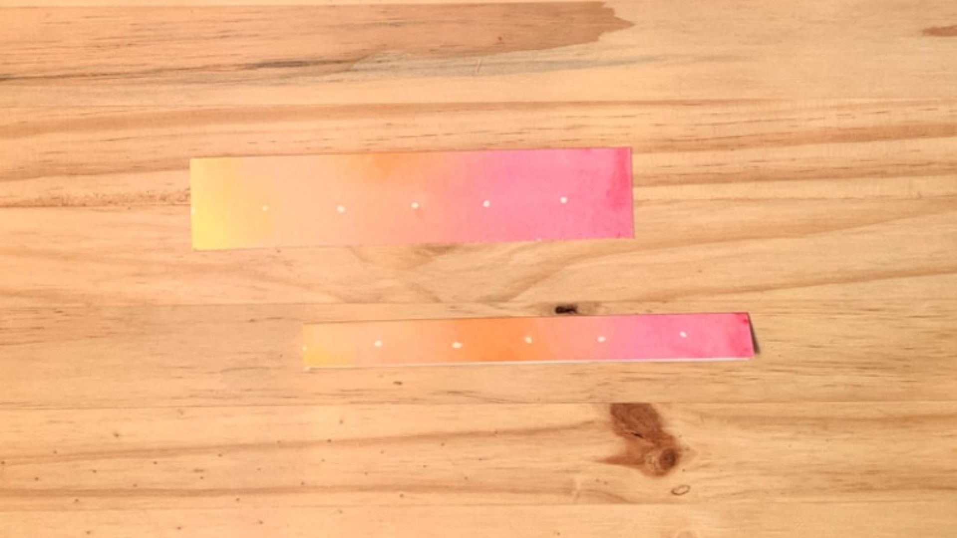 A piece of paper featuring a vibrant pink and yellow ombre pattern, blending smoothly from one color to the other