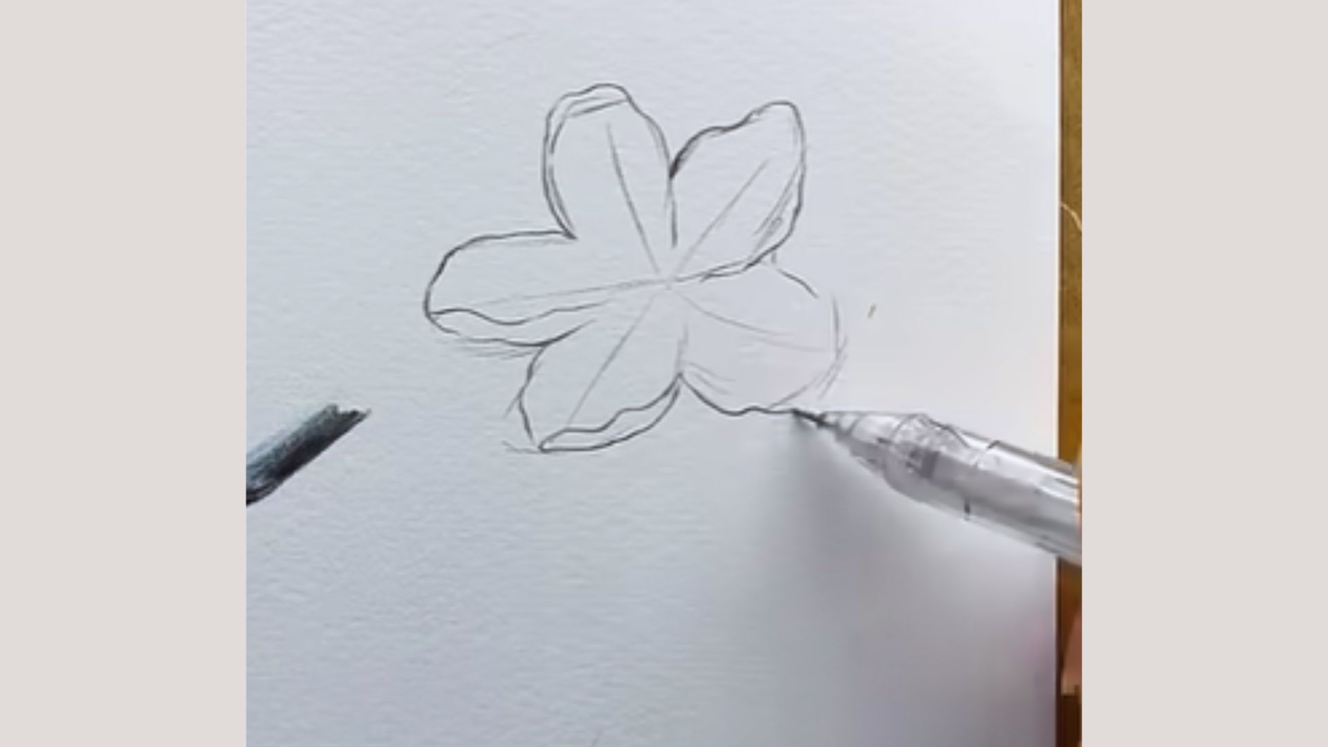 A pencil creating a flower illustration on paper, highlighting the artist's technique.