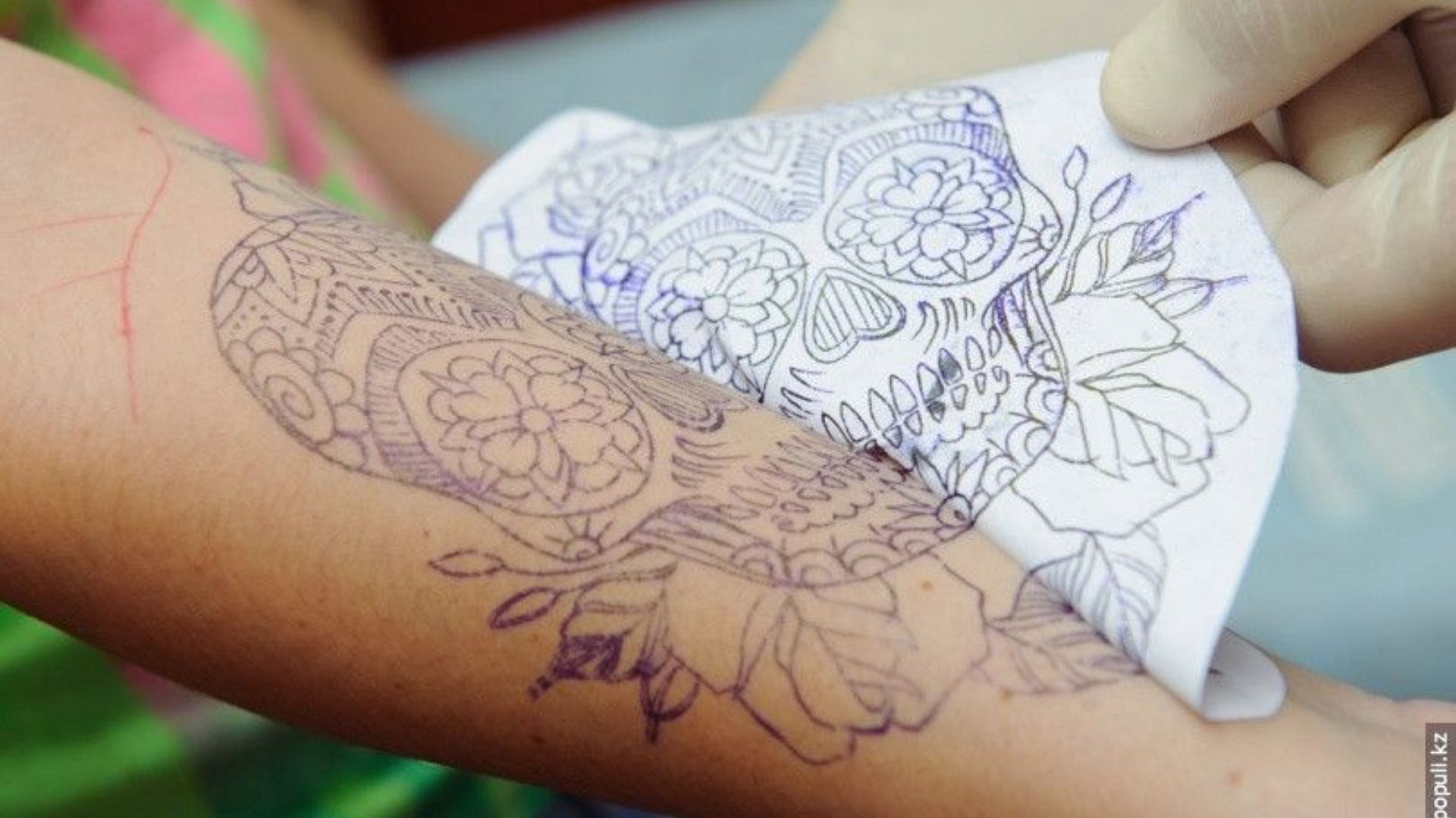 A person's arm adorned with a striking tattoo, highlighting intricate patterns and colors.