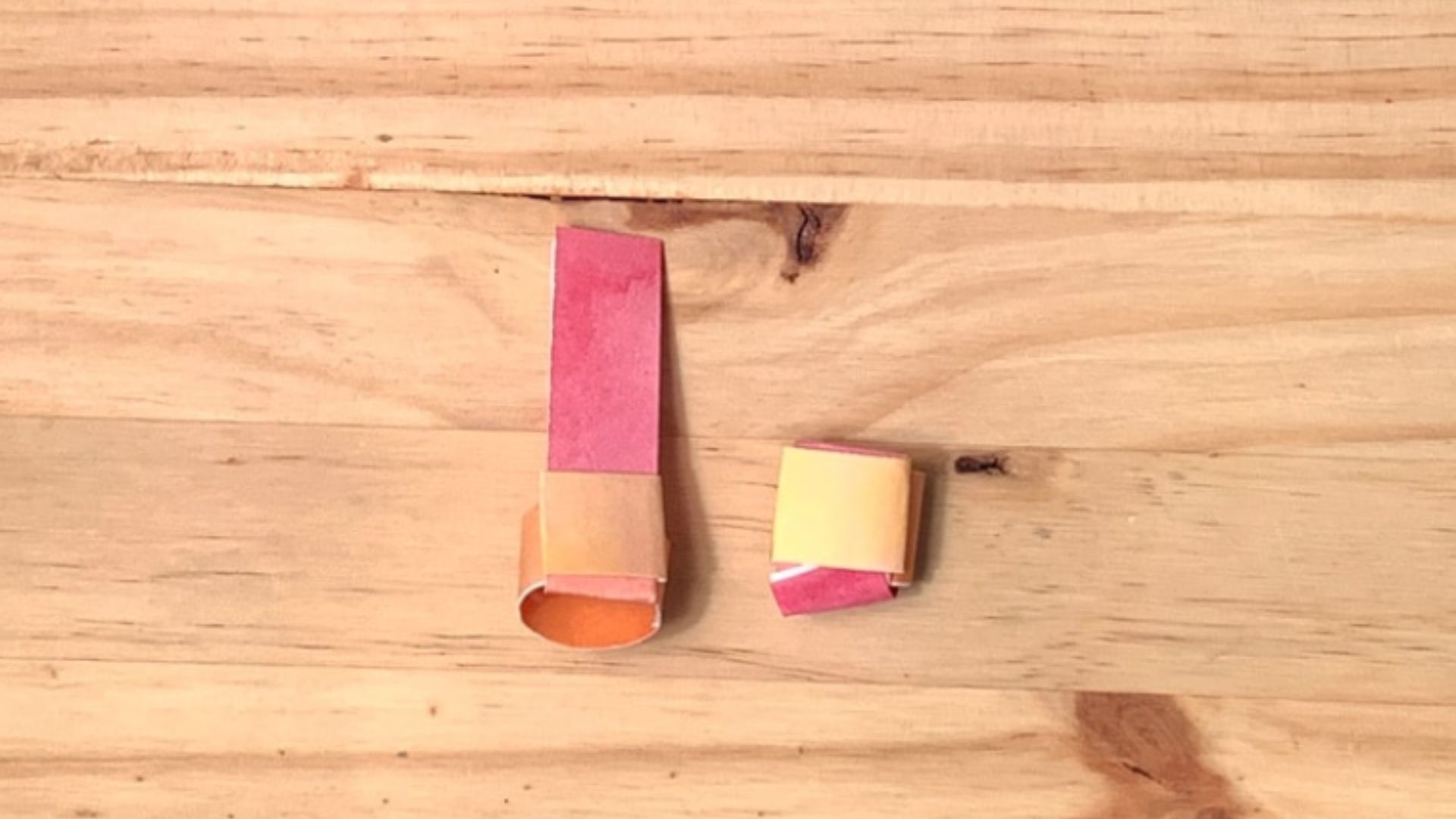 A pair of scissors positioned next to a blank sheet of paper, illustrating a crafting setup.