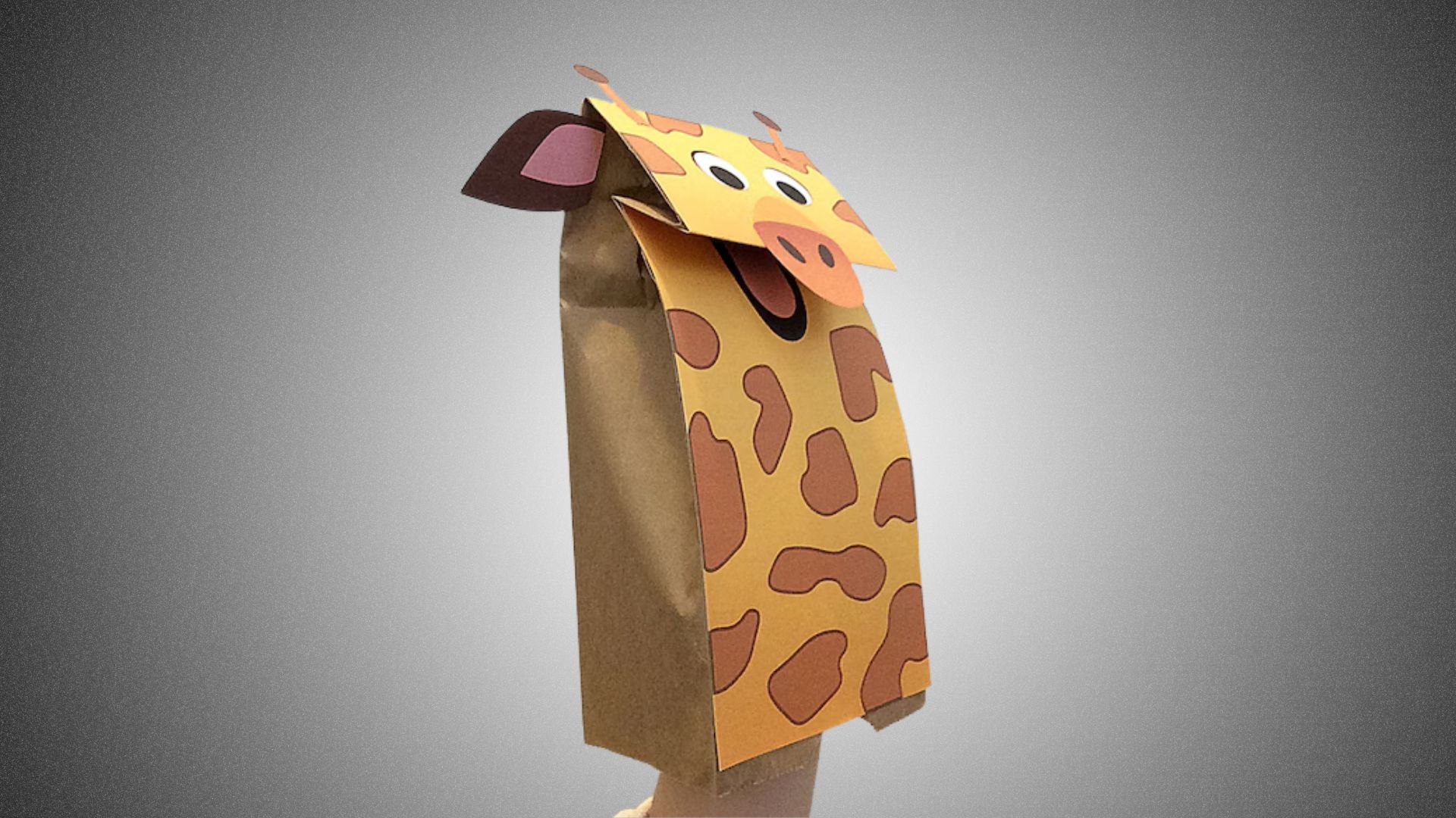 A paper bag featuring a colorful illustration of a giraffe on its surface.