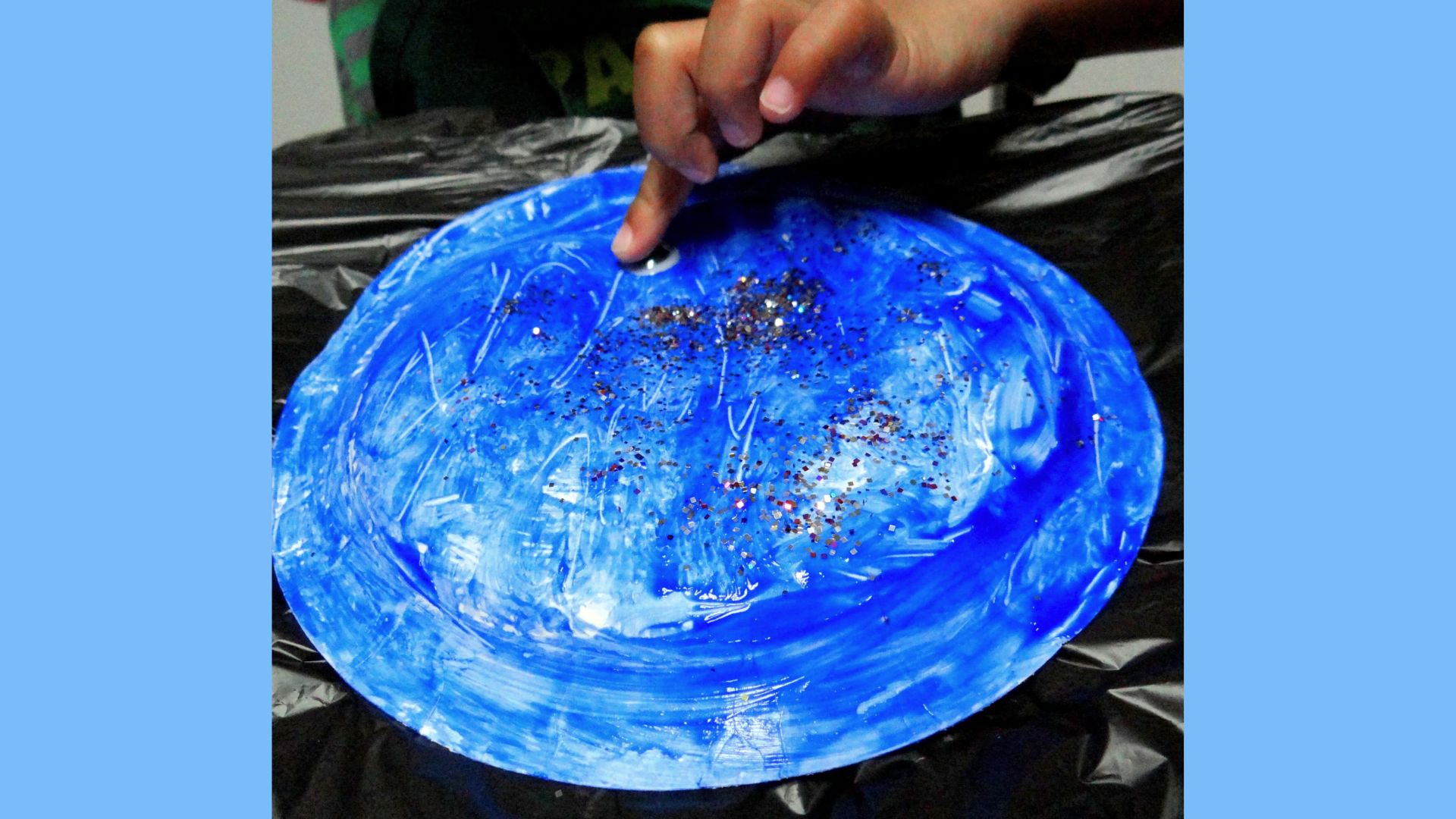 Step 2 of the Red Fish Blue Fish paper plate craft, showcasing colorful decorations on the plate.