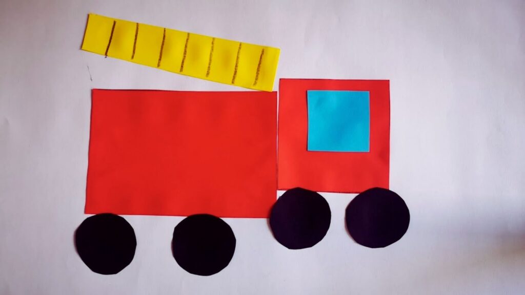 A colorful paper cutout of a fire truck, showcasing its details and design, ideal for a craft project.