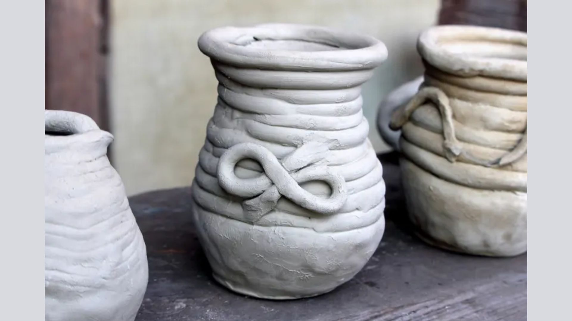 Three decorative clay vases featuring intricate designs in various colors and patterns.