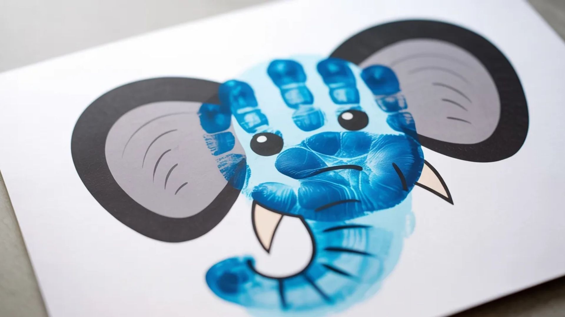 A colorful craft featuring a blue elephant handprint, showcasing creativity and artistic expression.