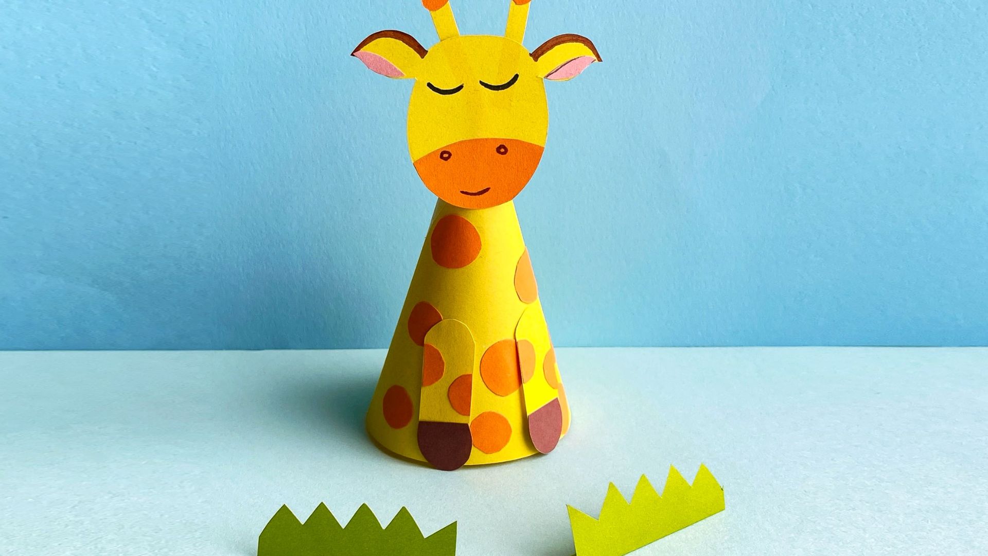 A paper giraffe wearing a hat, showcasing a creative and whimsical design.