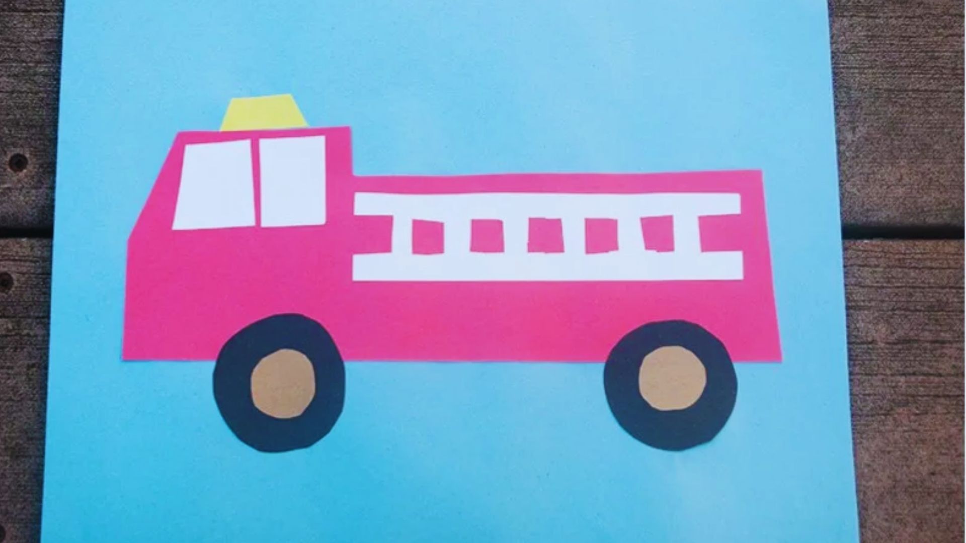 Colorful fire truck craft made from paper, designed for preschoolers to enhance creativity and fine motor skills.