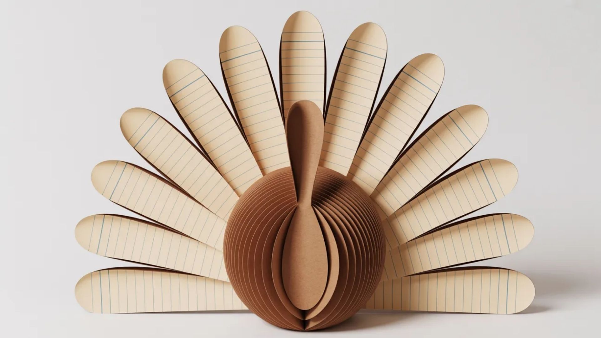 A handmade paper turkey crafted from colored paper, accompanied by a pencil for drawing or writing.