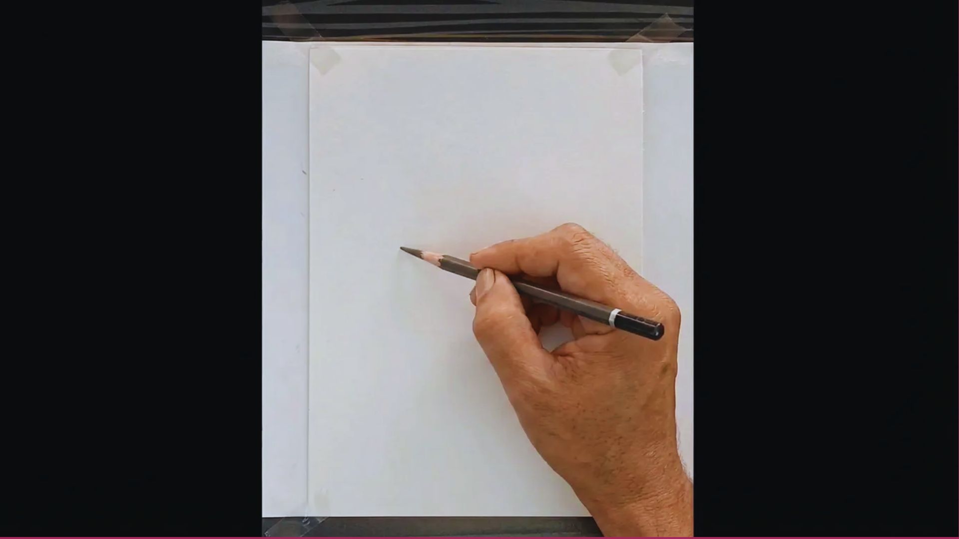 A person is focused on drawing on a piece of paper with a pencil, showcasing their artistic skills.