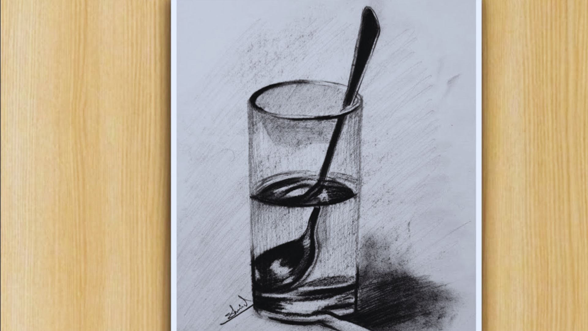 A drawing of a glass containing a spoon, showcasing a simple yet elegant design.