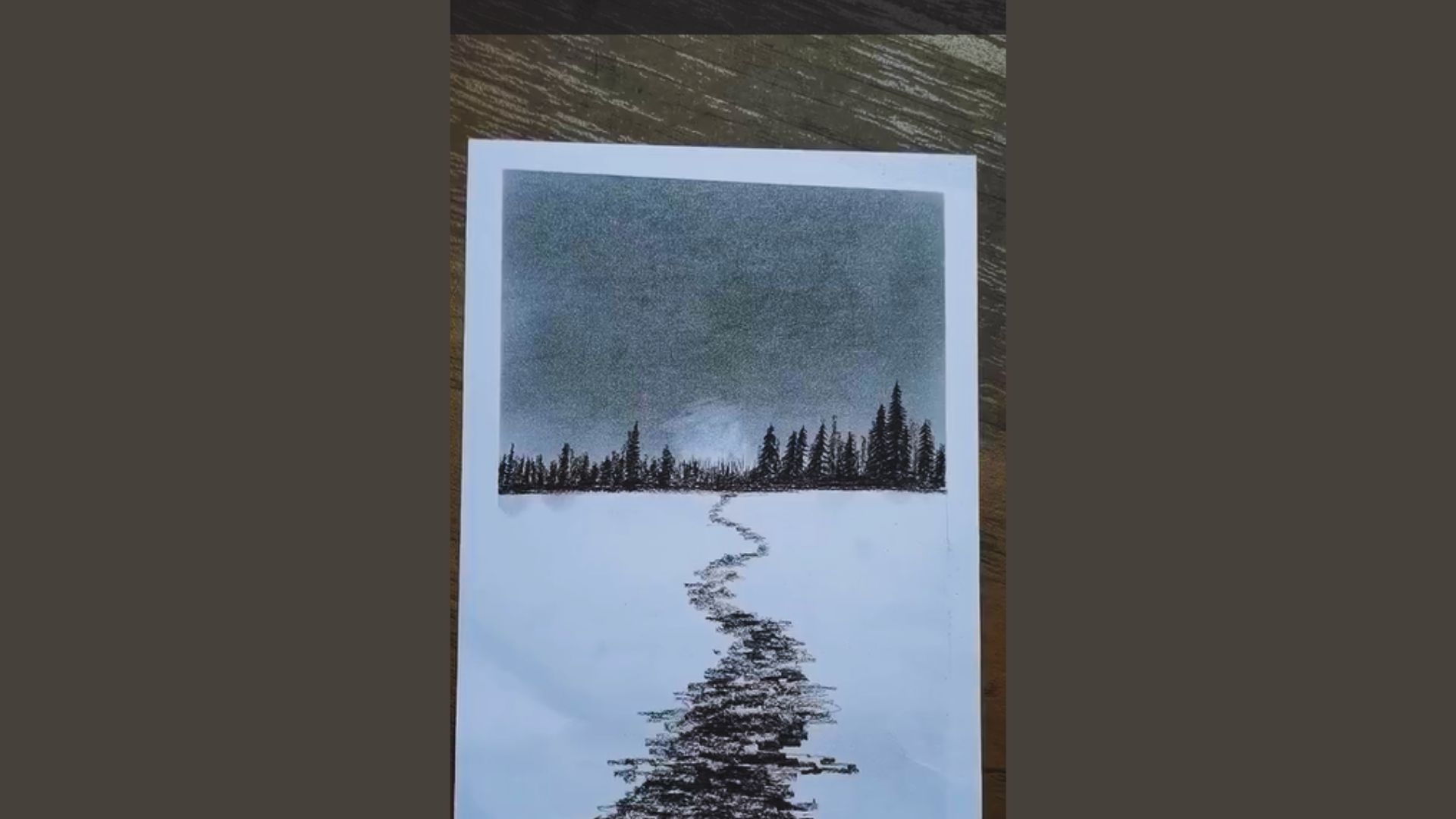 A drawing depicting a winding path through a snowy landscape, with soft snowflakes falling around it.