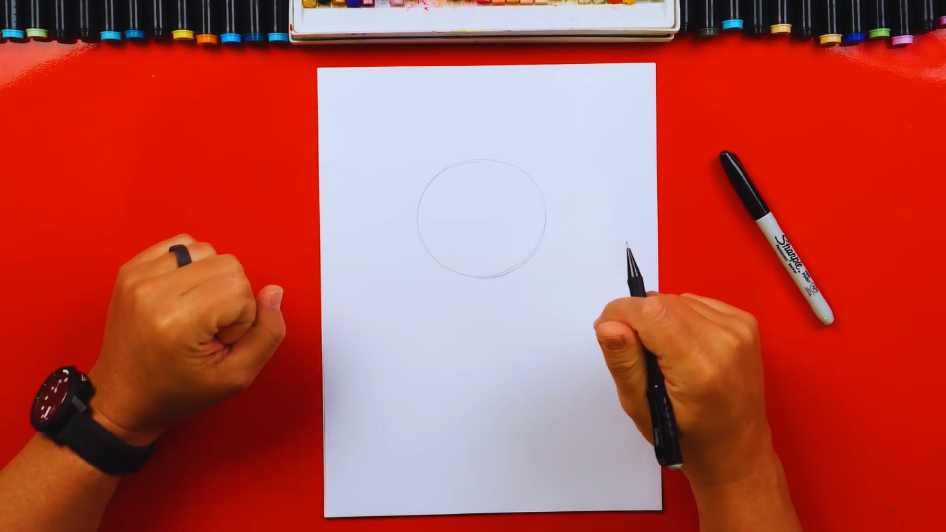 Step-by-step guide illustrating how to draw a perfect circle using a pen and paper.