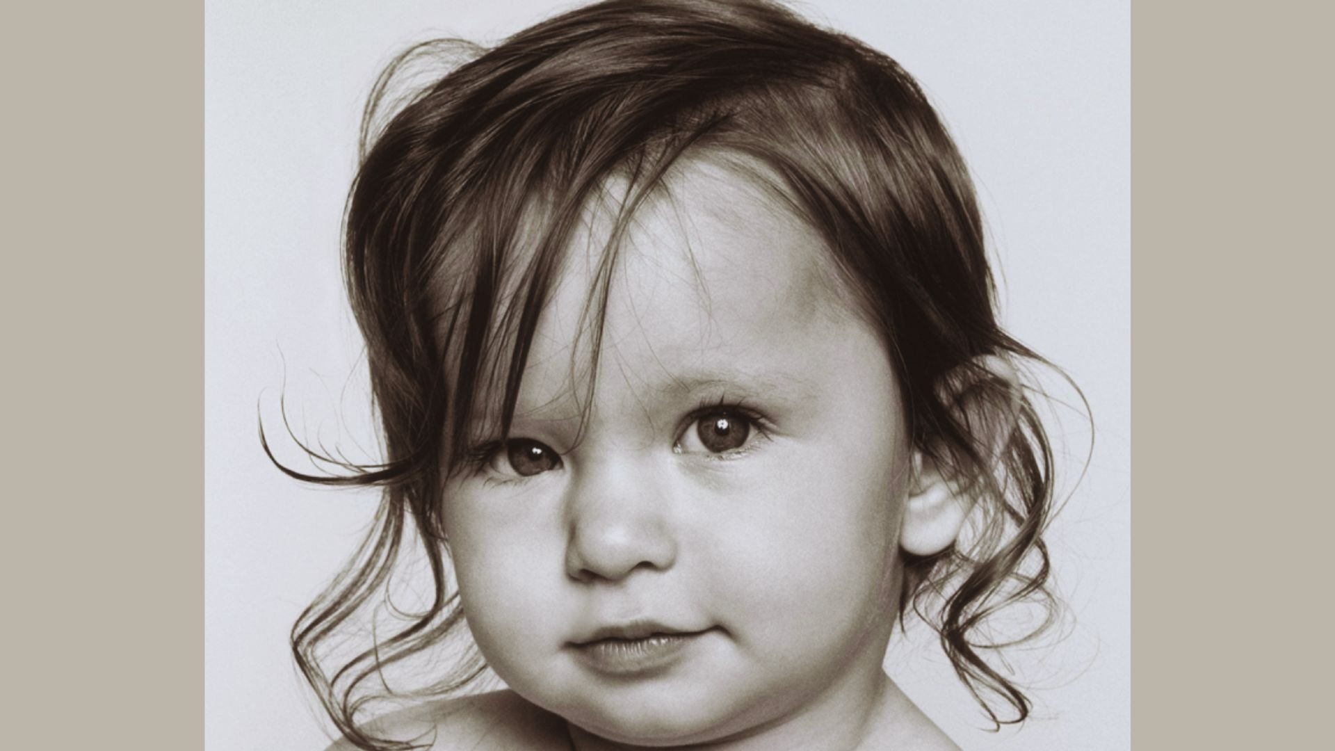 A black and white image of a baby, showcasing their delicate features and serene expression.