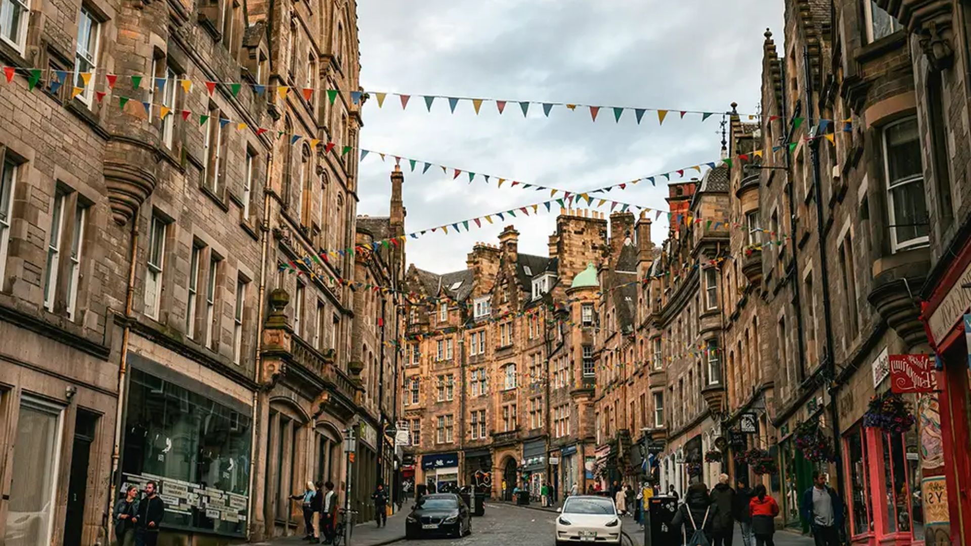 A street view of Edinburgh, Scotland, showcasing historic buildings and bustling sidewalks in March 2018.