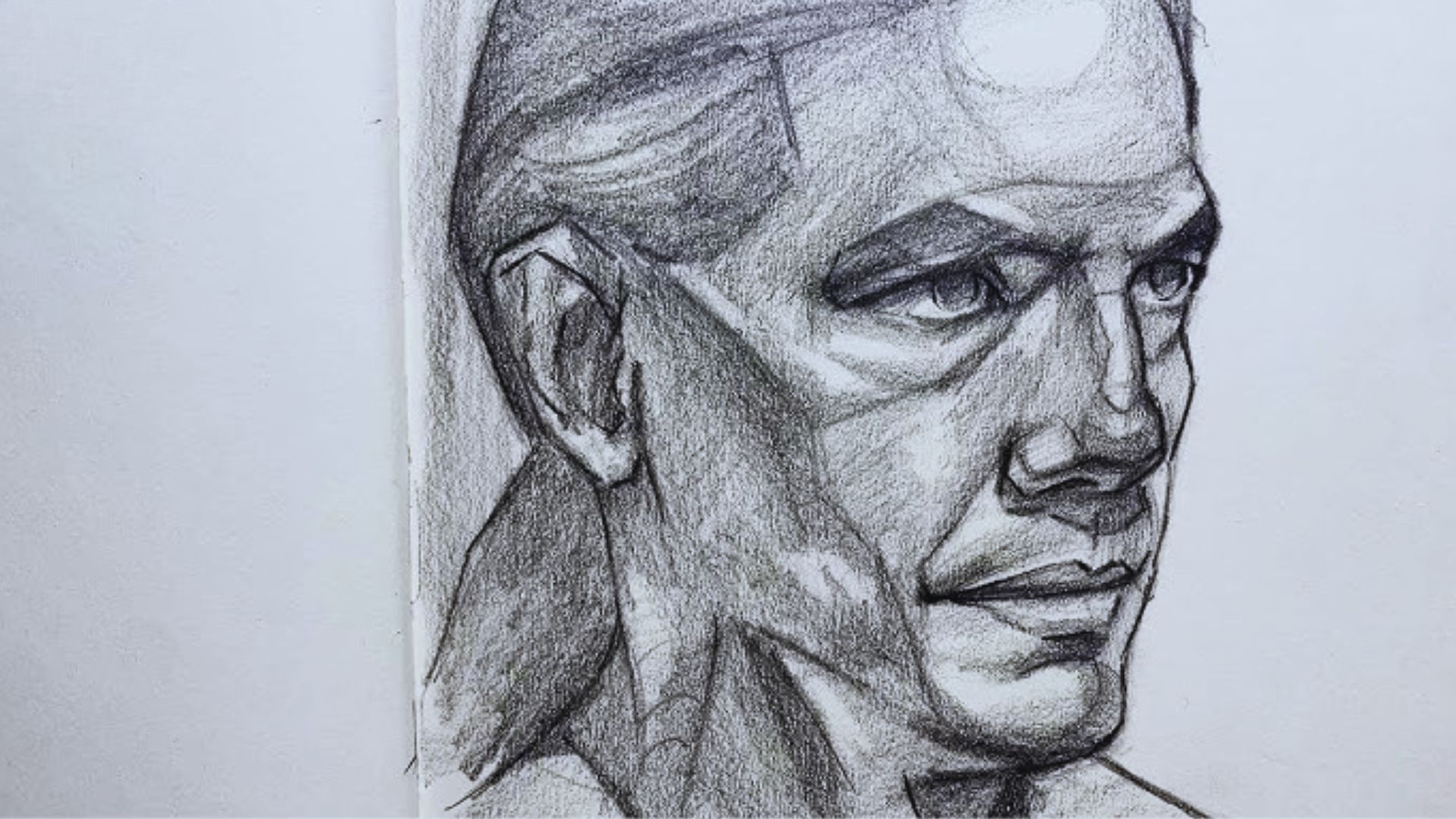 A drawing of a man with a ponytail, featuring a thoughtful expression and casual attire.