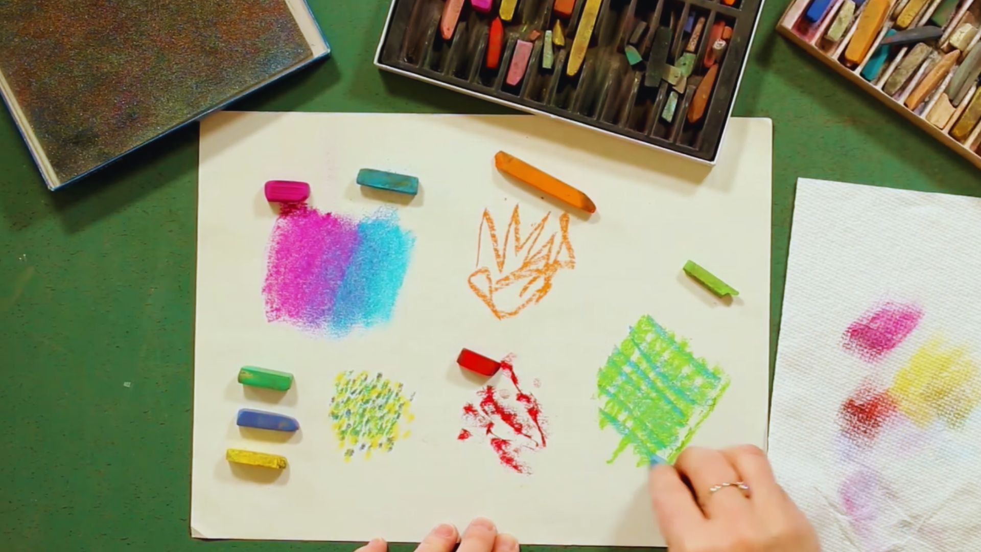 A person uses colored crayons to draw on a piece of paper, showcasing their creativity and artistic expression.