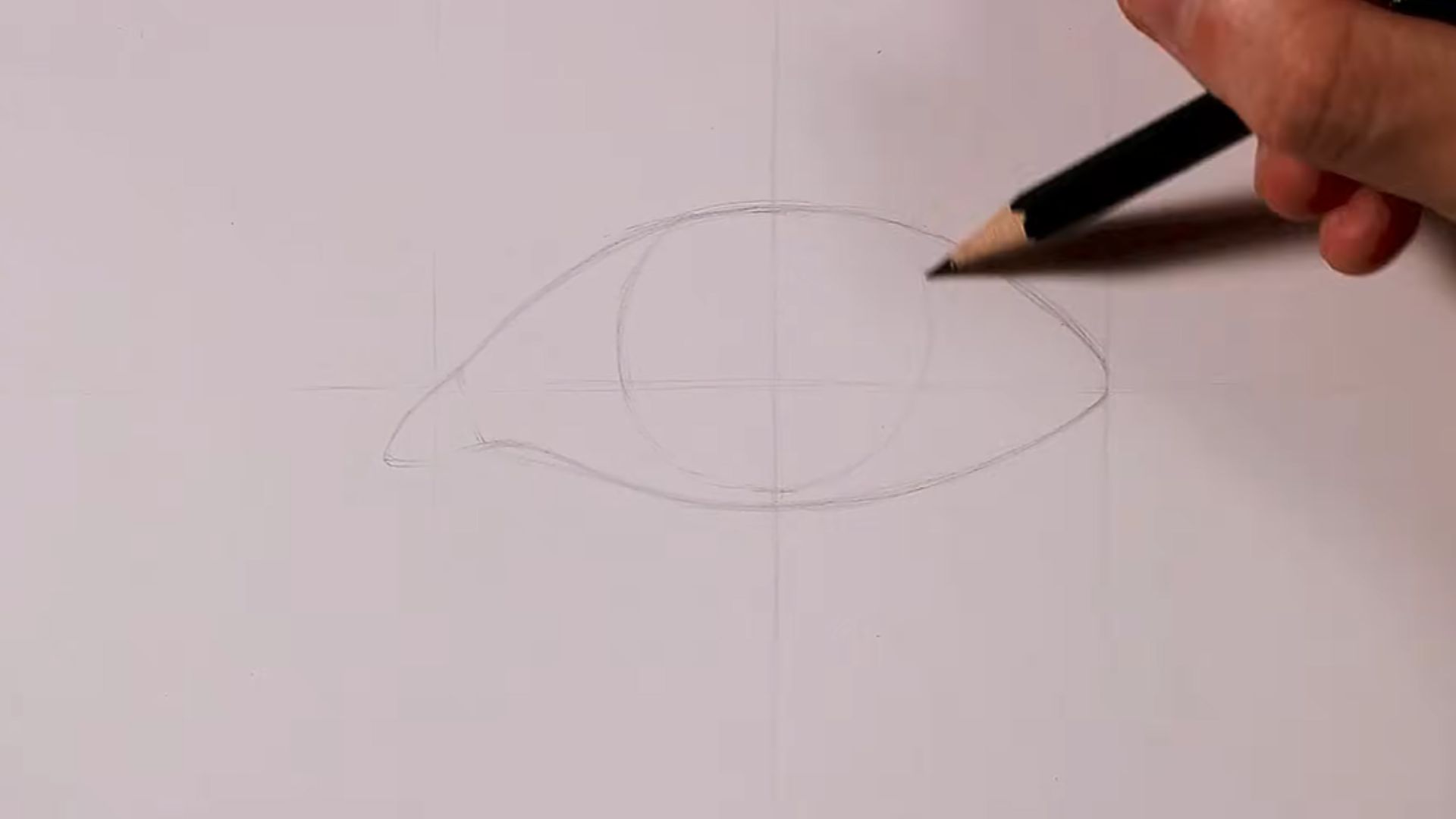 A person using a pencil to draw a perfect circle on a sheet of paper.