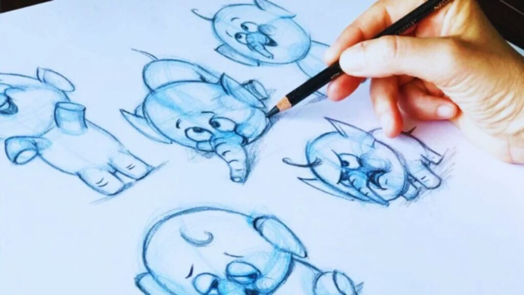 A person sketching a cartoon of a cute baby elephant on a drawing pad, surrounded by art supplies.