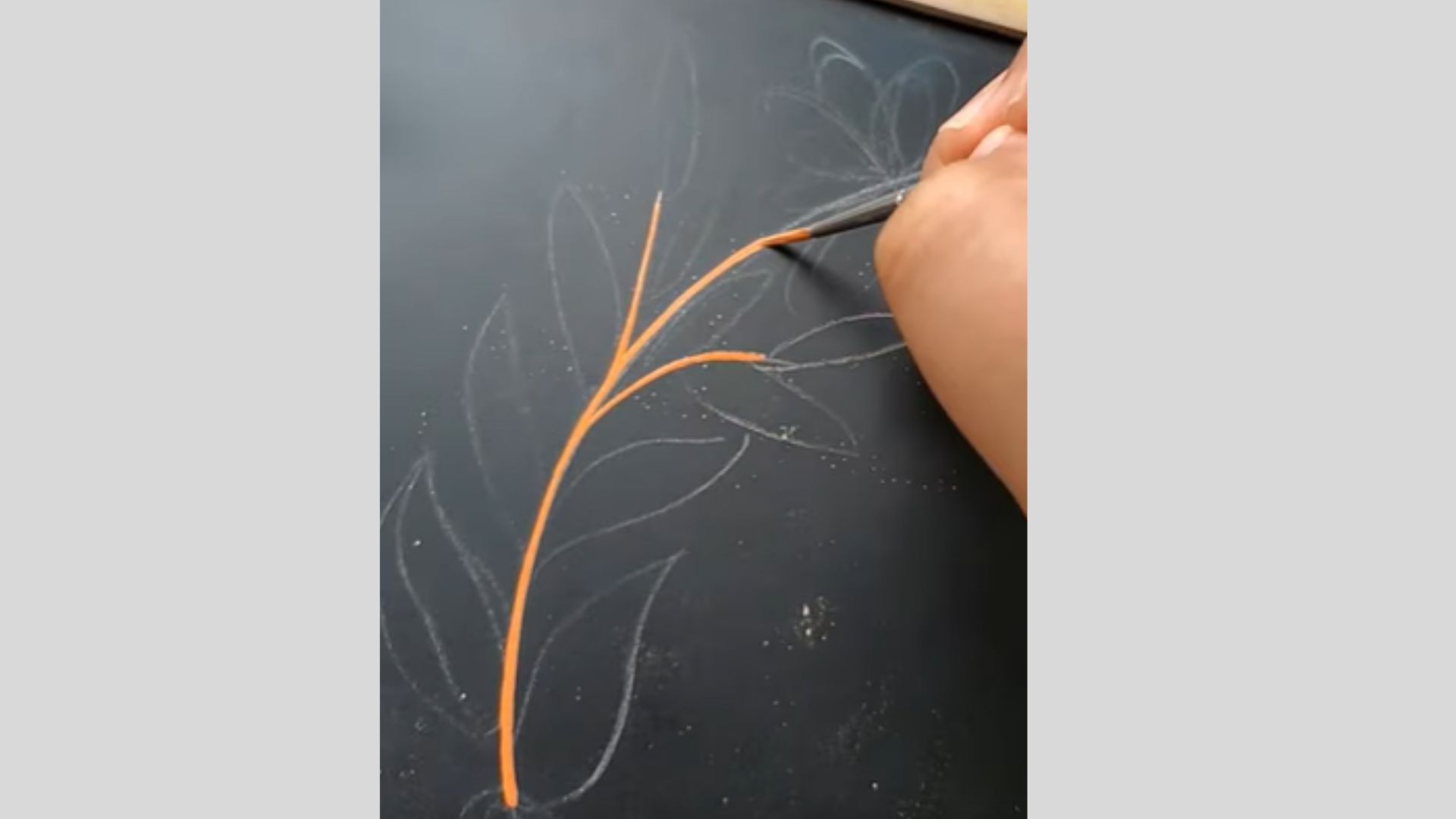 Fine brush painting orange branch carefully over light sketched chalkboard outline.