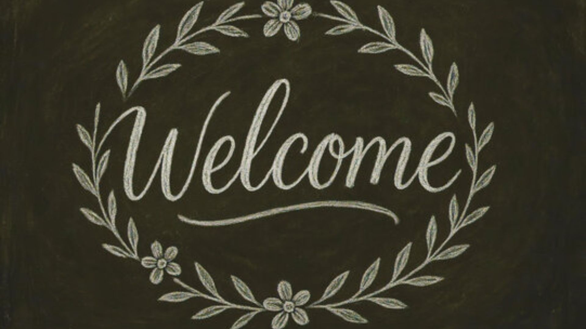 Welcome sign displayed on a chalkboard, featuring artistic lettering for a Chalkboard Art Project.