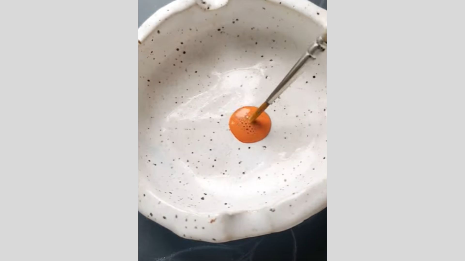 chalk Paint mixed with water in dish, forming smooth paint solution.