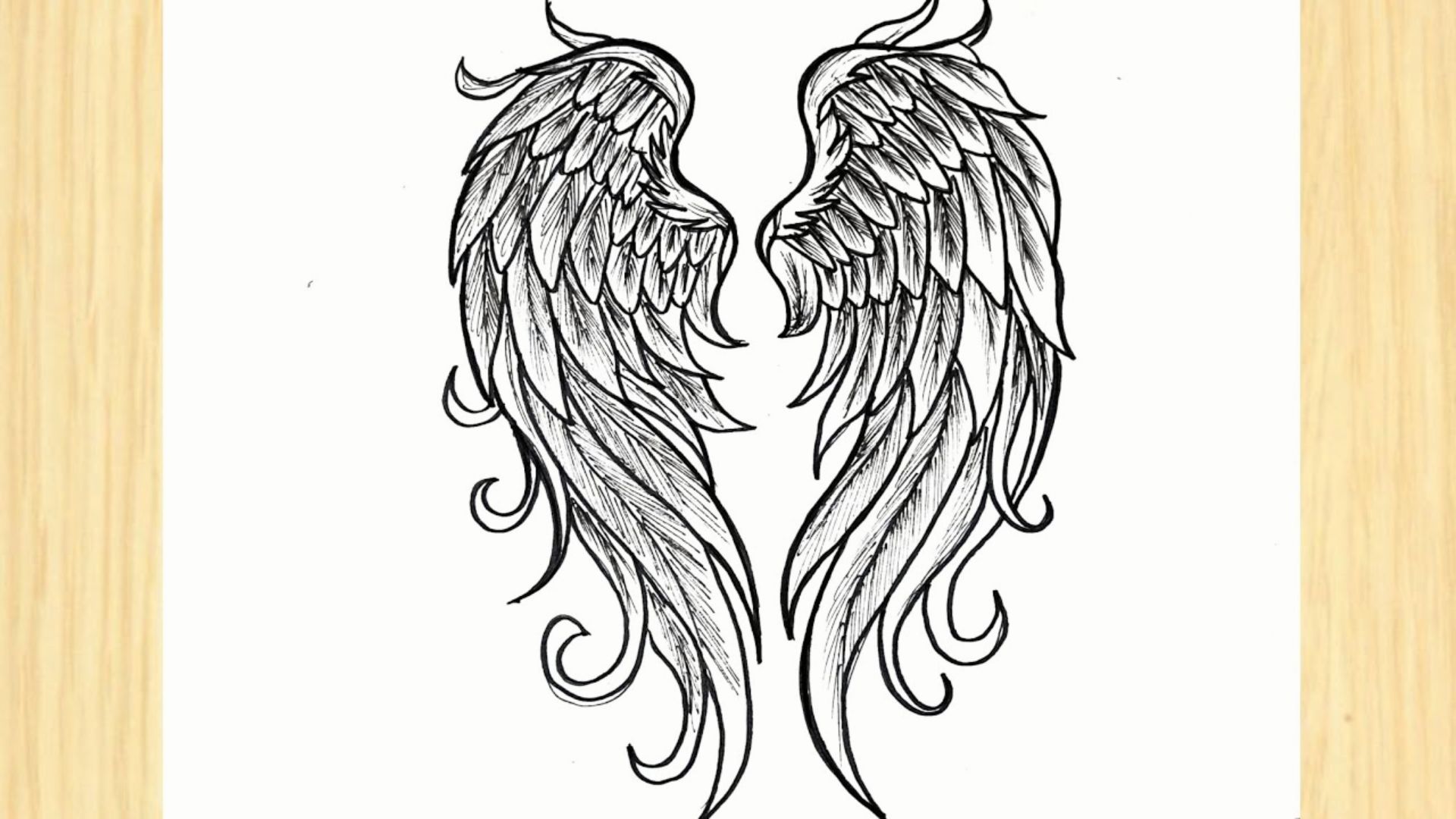 Drawing of two angel wings on a wooden frame, showcasing a simple and artistic design for easy replication.