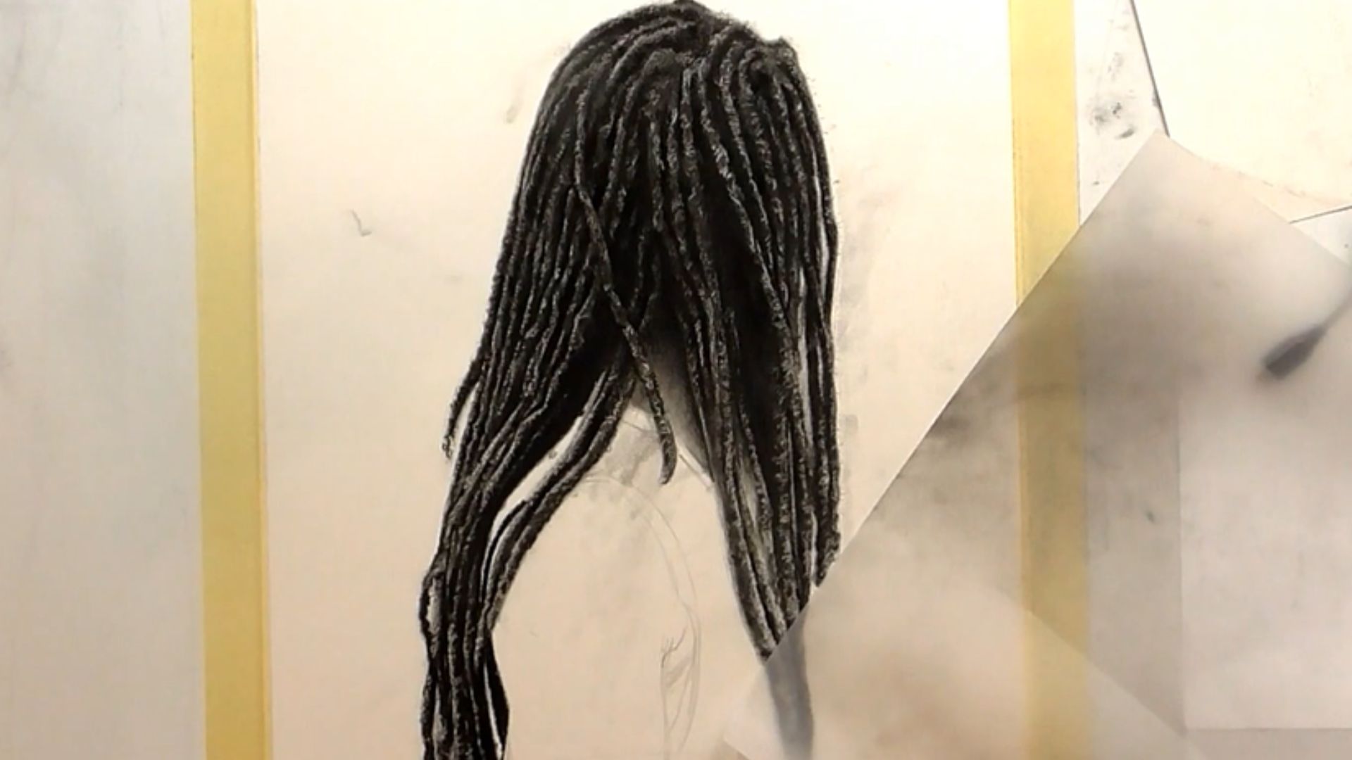 "A colorful mural of a woman with dreadlocks, highlighting her individuality and cultural representation on the wall."