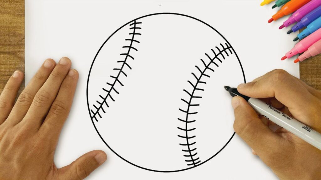 Hands draw bold baseball outline with black marker and markers nearby for simple coloring page