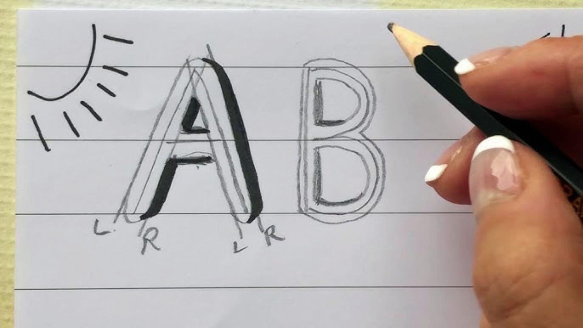 Hand with French-tip nails sketches shadow guides on the letter “A” next to a pencil-outlined “B”.