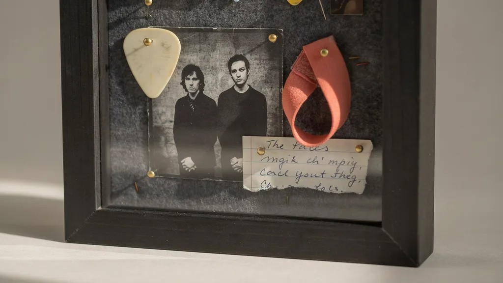 Music lover's shadow box with concert memorabilia.