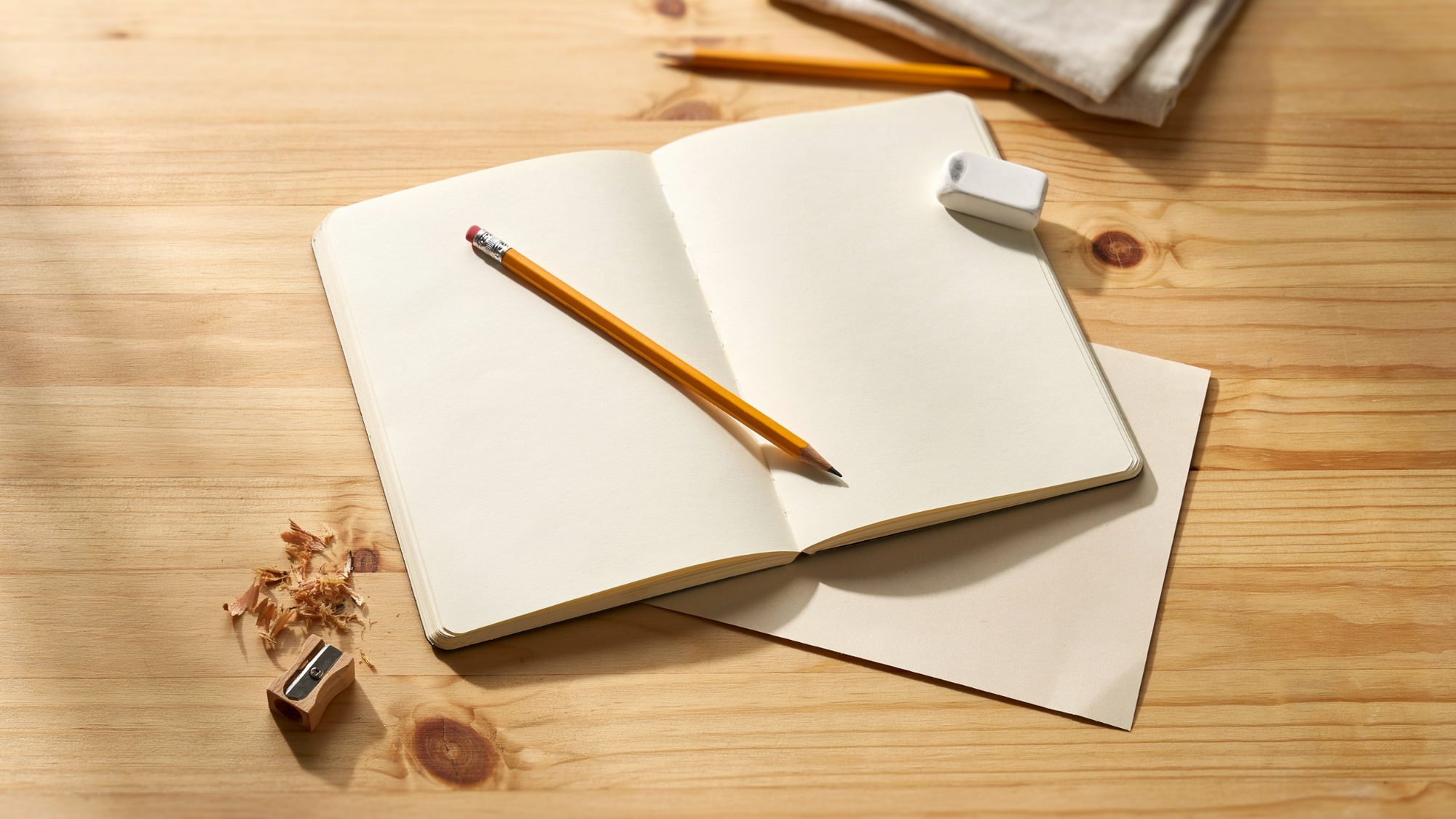 Basic drawing supplies including pencil, eraser, paper, and sketchbook.
