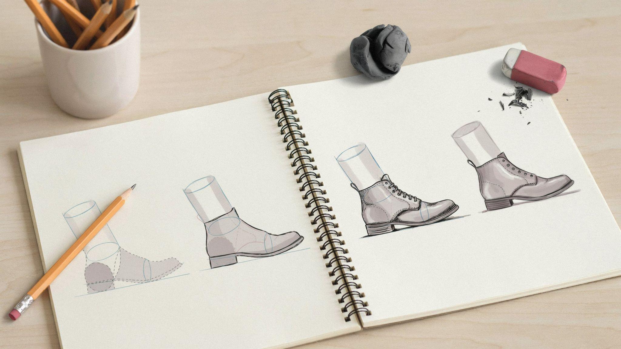 Boot sketching steps on spiral notebook, from basic shapes to detailed lace up boot.