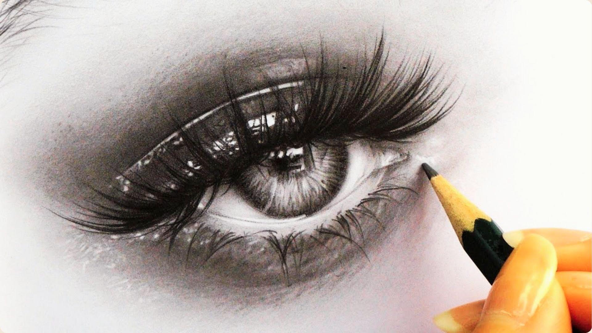 A hand holding a sharpened pencil adds fine details to the outer corner, showing advanced eyelash rendering techniques.