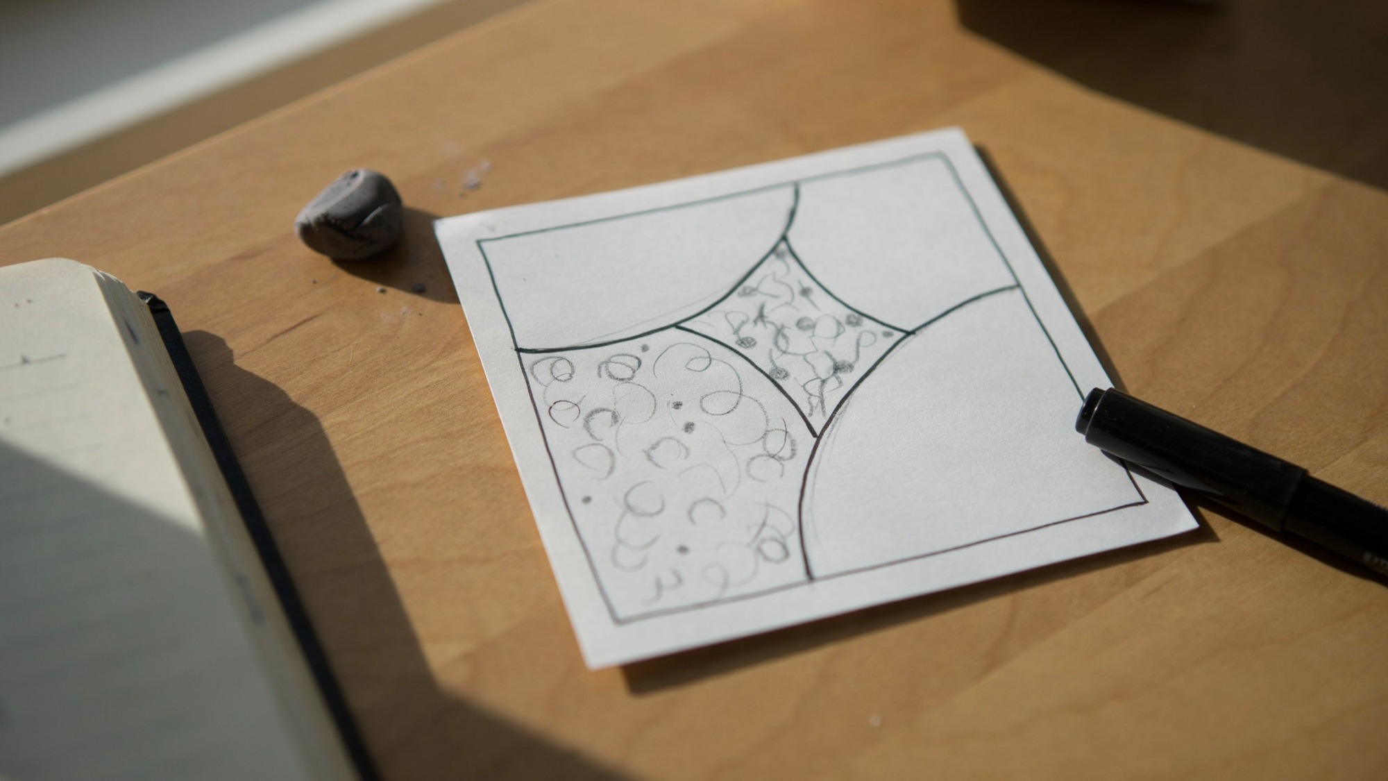 Beginner starting a Zentangle tile with simple sections.