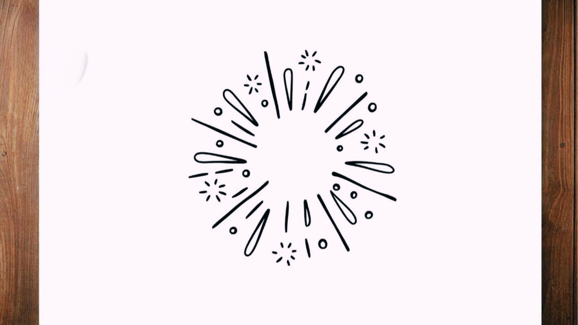 Black line art of firework burst with dots and stars on white paper framed by wood edges